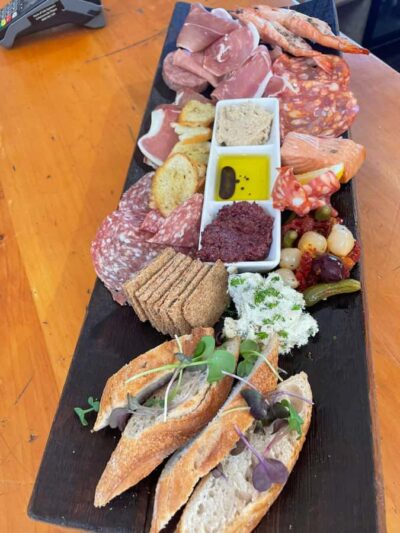 Waiheke: Scenic Taste and Graze Tour with Wine, Whisky, Beer - Mudbrick Vineyard: wine tasting with Rangitoto and Auckland views